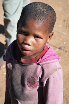 San Bushmen children are some of the most disadvantaged and discriminated in the world. This little girl could only dream of a few items of school uniform and a blanket.